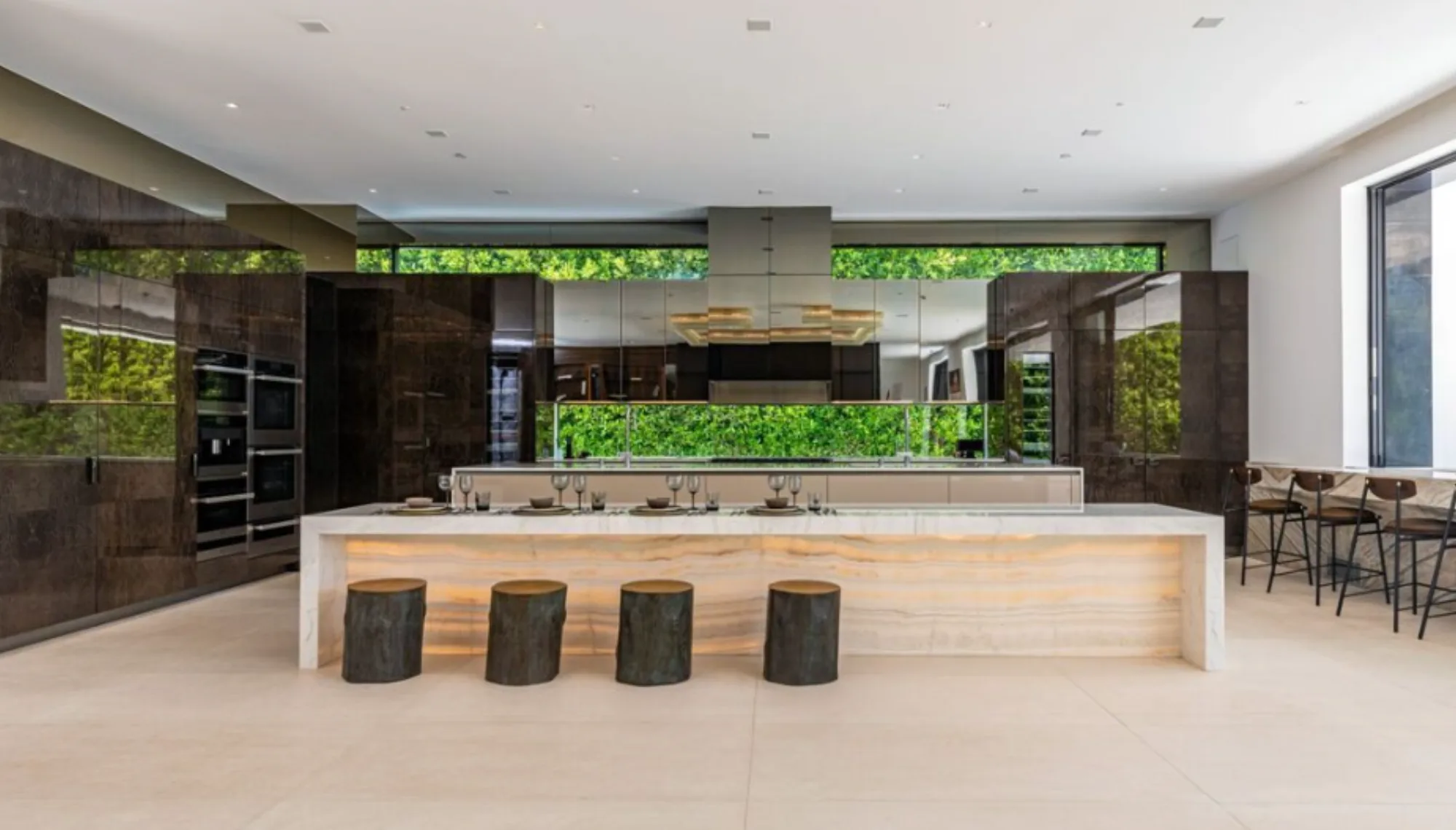 CAD Stone Works backlit translucent onyx kitchen island counter and custom natural stone surfaces at Beverly Hills Flats Residence.