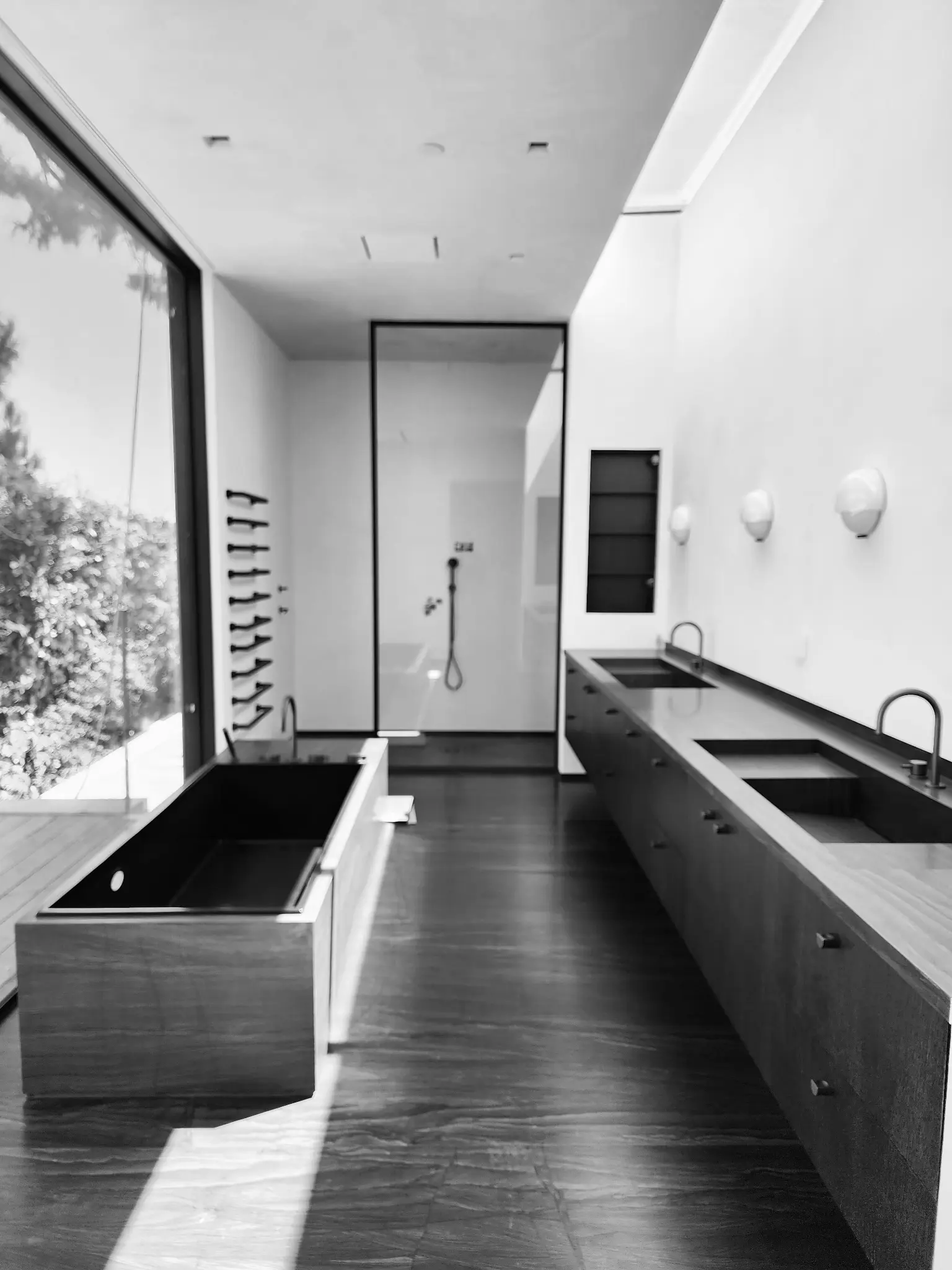 Ember House master bathroom in honed Black Diamond VC with integrated sinks and tub surround