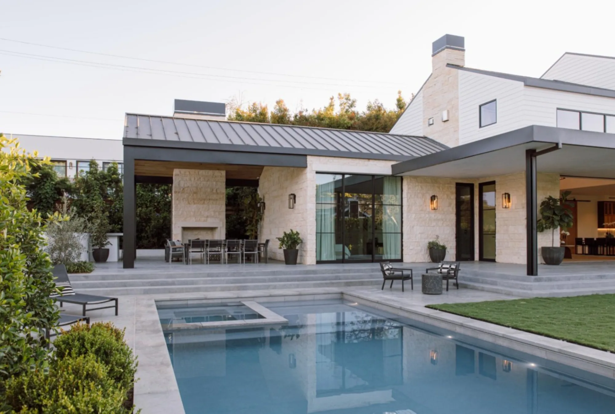Blue Saint Louis Limestone exterior patio flooring, pool coping, and cabana at the Lombard Estate in Pacific Palisades, fabricated and installed by CAD Stone Works